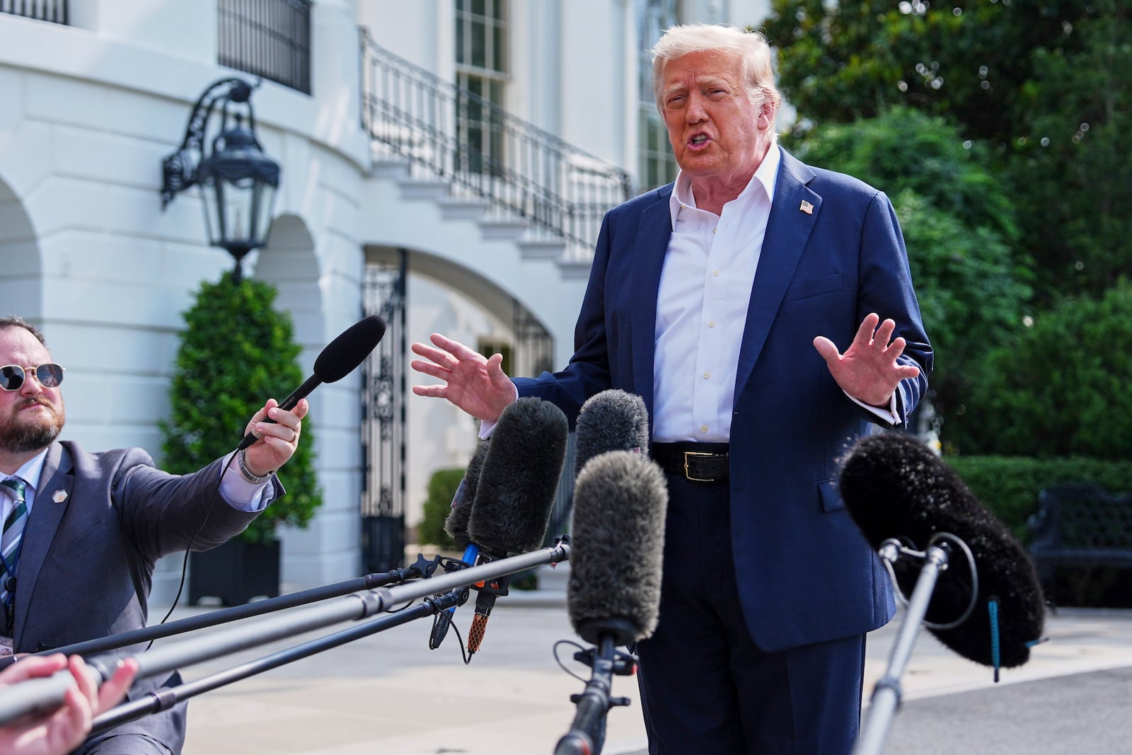 President Donald Trump speaks with reporters before departing the White House, Friday, July 11, 2025, in Washington. (AP Photo/Evan Vucci)