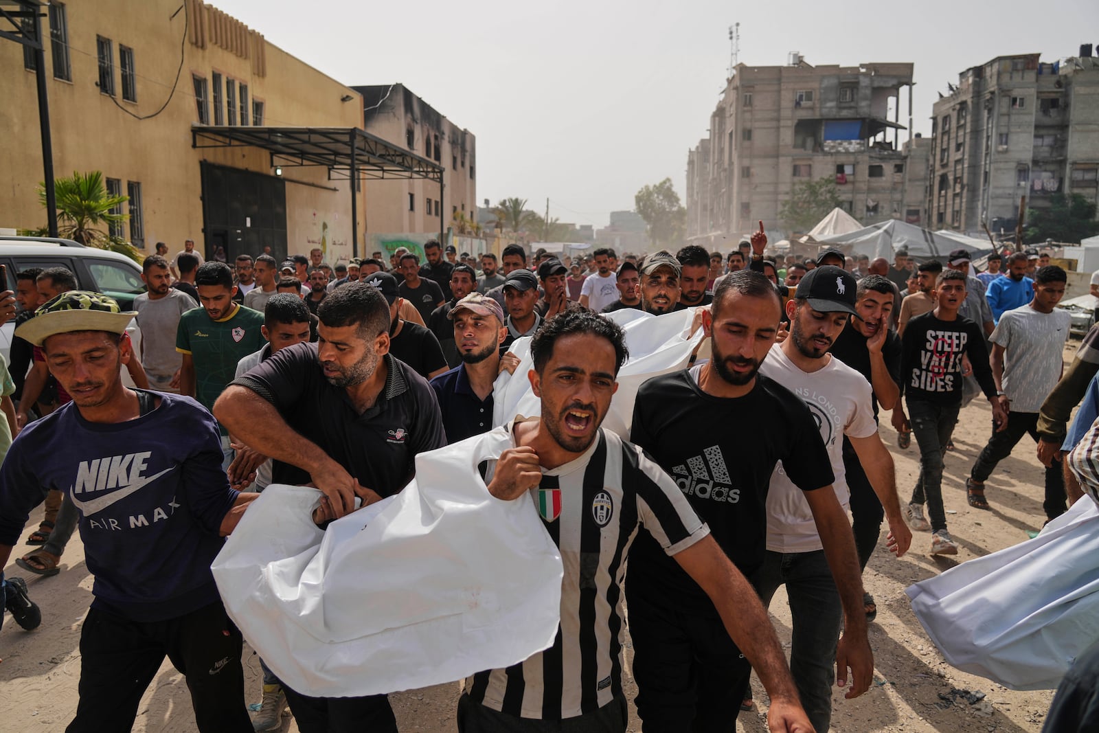 Palestinians carry the bodies of their relatives killed in an Israeli army airstrike, during their funeral in Khan Younis, Gaza Strip, Sunday, May 18, 2025. (AP Photo/Abdel Kareem Hana)