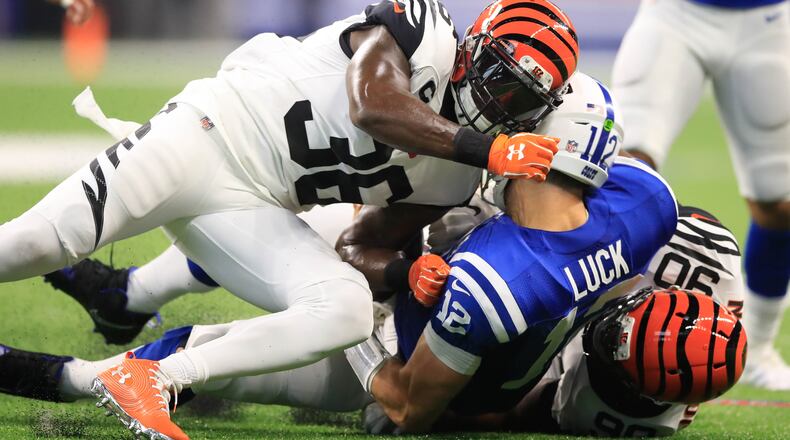 INDIANAPOLIS, IN - SEPTEMBER 09: Andrew Luck #12 of the Indianapolis Colts is taken down by Darius Phillips #38 and Michael Johnson #90 of the Cincinnati Bengals at Lucas Oil Stadium on September 9, 2018 in Indianapolis, Indiana. (Photo by Andy Lyons/Getty Images)