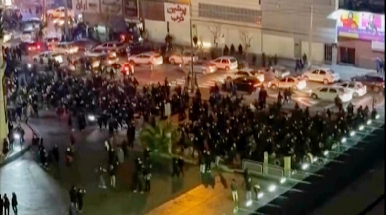 FILE - In this image from video made by an individual not employed by The Associated Press and obtained by the AP outside Iran, people block an intersection during a protest in Tehran, Iran, on Jan. 8, 2026. (UGC via AP, File)