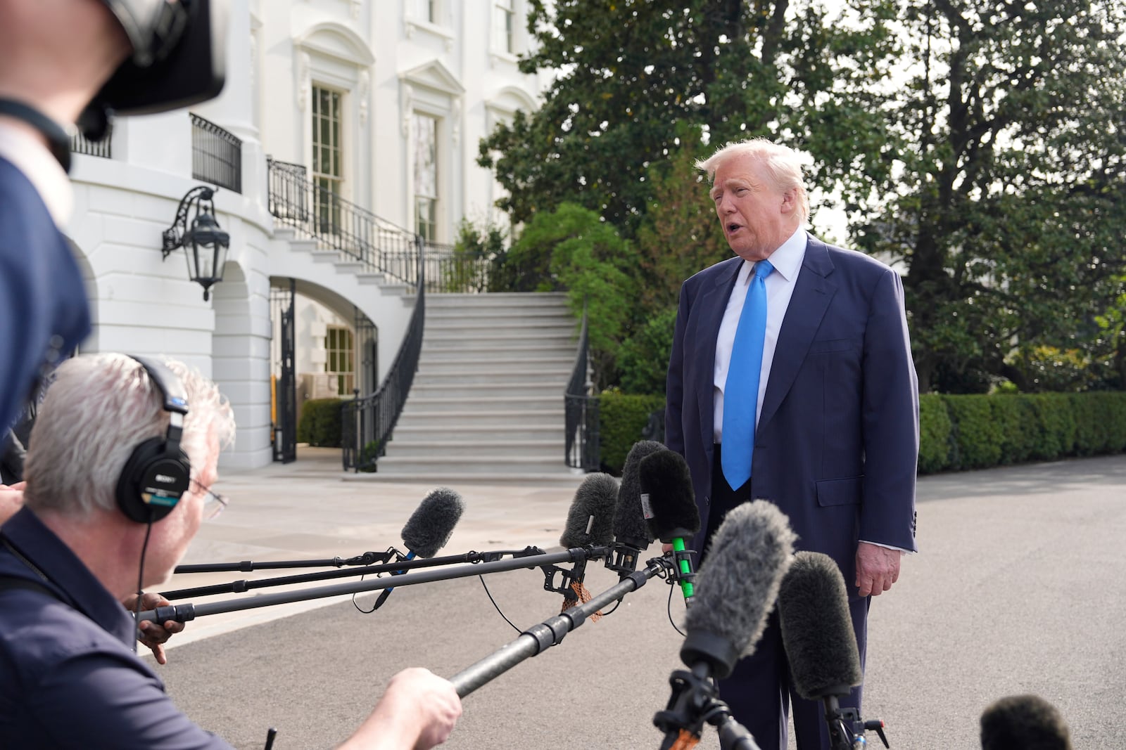 President Donald Trump speaks with reporters as he and first lady Melania Trump depart on Marine One from the South Lawn of the White House, Friday, April 25, 2025, in Washington. The President and first lady will be traveling to Rome and the Vatican to attend the funeral for Pope Francis. (AP Photo/Alex Brandon)