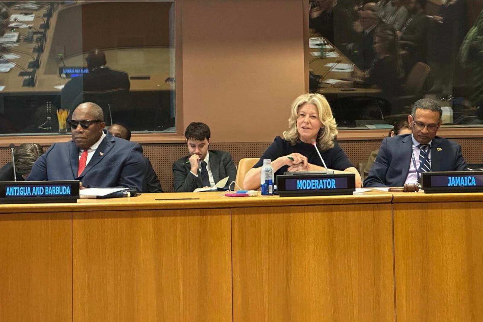 This undated photo provided by Gabrielle Blackwood shows moderator Laura Trevelyan, center with Antigua's U.N. Ambassador Walton Webson, left, and Jamaica's U.N. Ambassador Brian Wallace, right, during a meeting of descendants of slave owners and slaves in former British colonies in the Caribbean at U.N. headquarters . (Gabrielle Blackwood via AP)