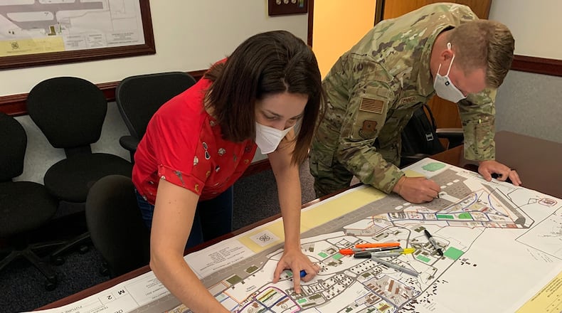 Sandrine Prazeres, installation manager at Lajes Field, and Capt. Andrew Fenner, Air Force Institute of Technology’s Civil Engineer School planning instructor, work to illustrate a revised district boundaries map for the installation as part of the CE School’s consultation to develop a base master plan for the 65th Air Base Group. U.S. AIR FORCE PHOTO/MAJ. SEAN-MICHAEL KELLY