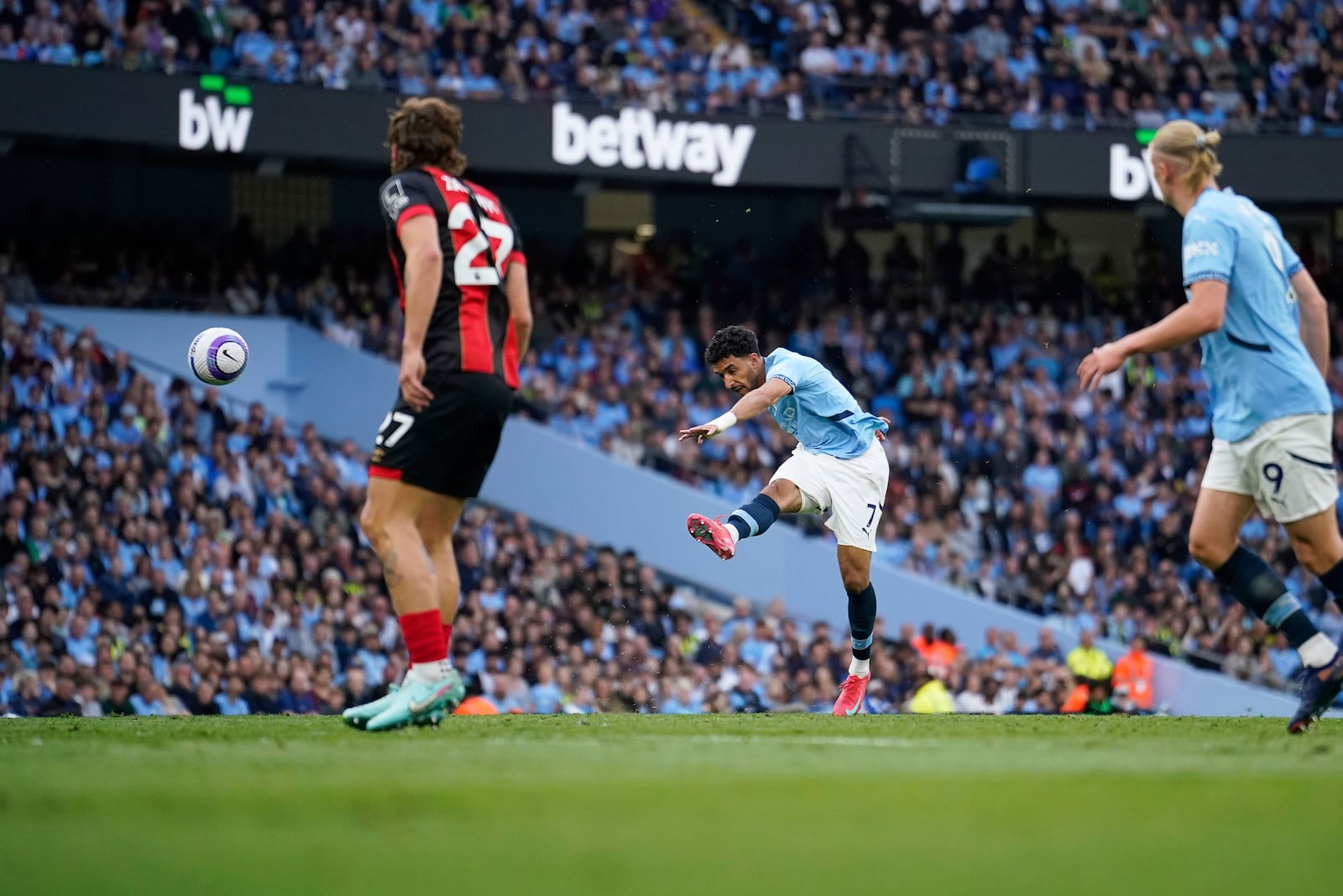 Manchester City's Omar Marmoush scores his side's opening goal during the English Premier League soccer match between Manchester City and Bournemouth at the Etihad stadium in Manchester, England, Tuesday, May 20, 2025. (AP Photo/Dave Thompson)