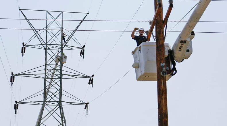 DP&L linemen repair electrical lines near Kuntz Road in Old North Dayton’s industrial park in June 2019. FILE