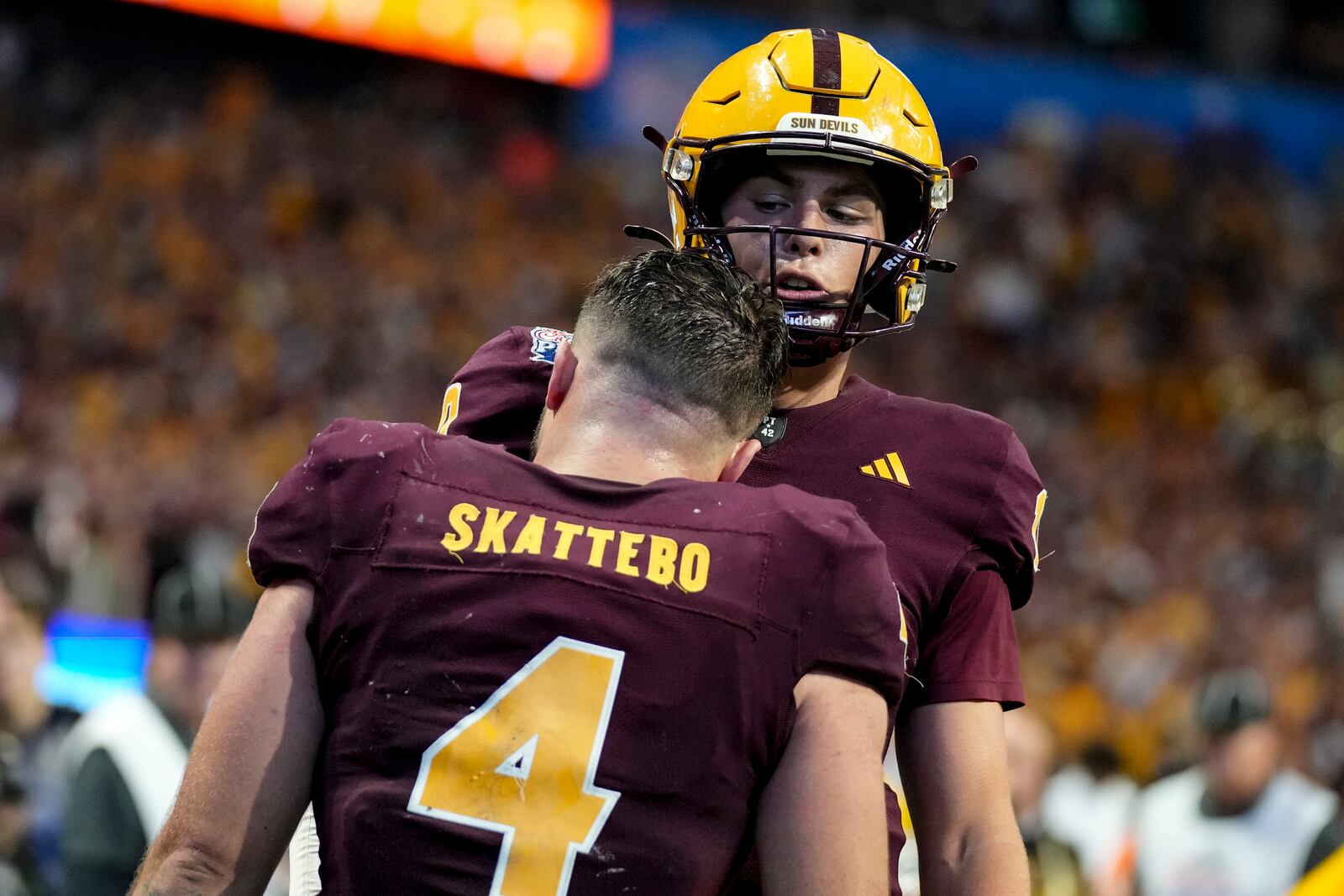FILE - Arizona State running back Cam Skattebo (4) celebrates his touchdown against Texas with Arizona State quarterback Sam Leavitt during the second half in the quarterfinals of a College Football Playoff game, Wednesday, Jan. 1, 2025, in Atlanta. (AP Photo/Brynn Anderson, File)
