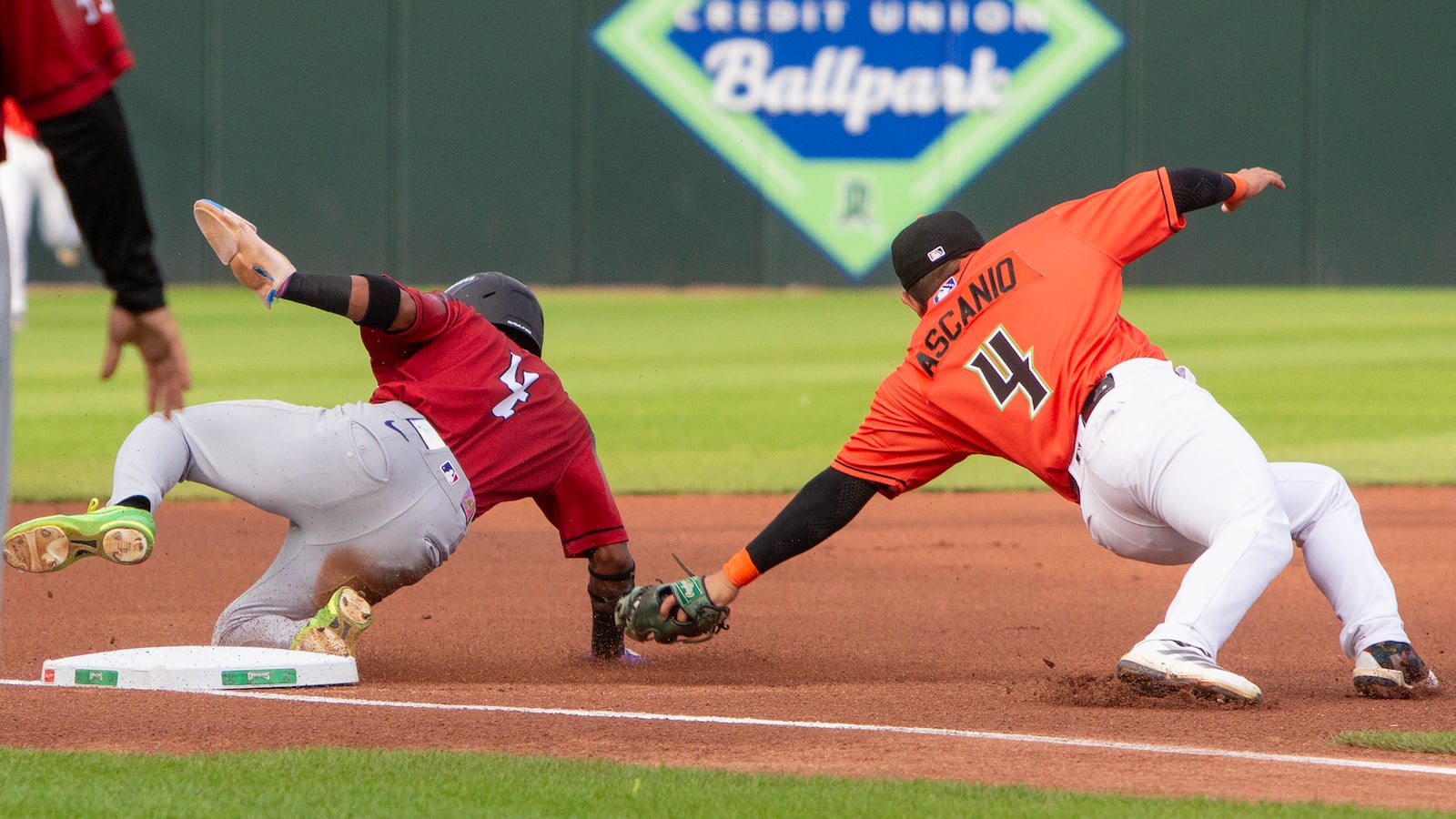 Great Lakes' Kendall George steals third base as Johnny Ascanio tries to tag him after fielding a high throw from catcher Connor Burns. George later scored for a 1-0 lead in the first inning Friday night at Day Air Ballpark. Jeff Gilbert/CONTRIBUTED