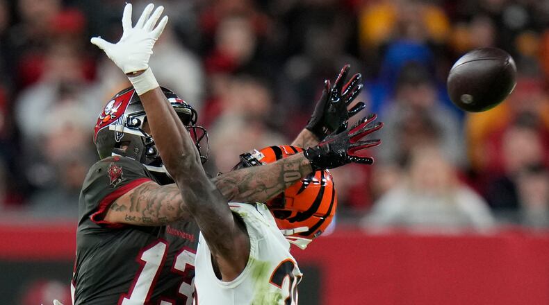 Tampa Bay Buccaneers wide receiver Mike Evans (13) misses the catch as Cincinnati Bengals safety Dax Hill (23) defends during the second half of an NFL football game, Sunday, Dec. 18, 2022, in Tampa, Fla. (AP Photo/Chris O'Meara)