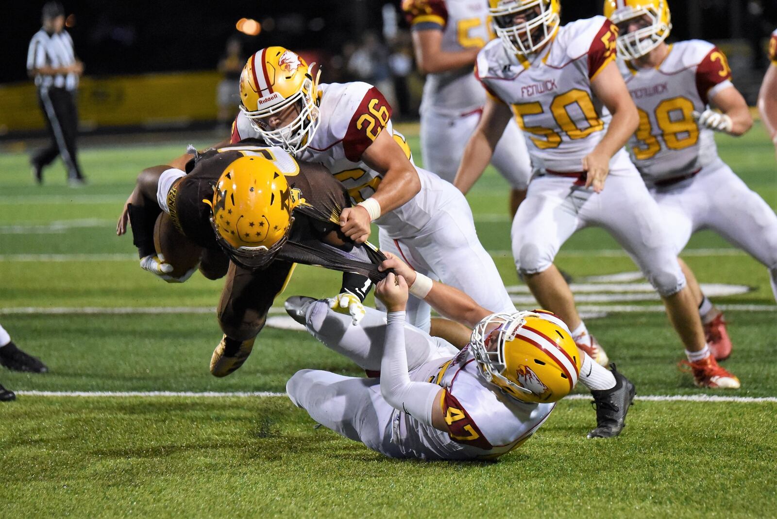 Fenwick’s Ben Gustely (47) and Logan Miller (26) tackle Alter’s Lamar Landers (6) during a Sept. 21 game at Centerville Stadium. Landers’ Knights won 45-20. CONTRIBUTED PHOTO BY ANGIE MOHRHAUS