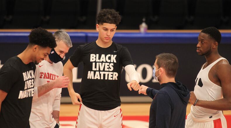 Dayton players, including Koby Brea, center, huddle before a game against Mississippi on Saturday, Dec. 19, 2020, at UD Arena. David Jablonski/Staff