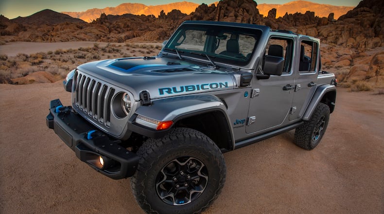 This photo provided by Fiat Chrysler shows the 2021 Jeep Wrangler Rubicon 4xe.  Fiat Chrysler on Thursday, Sept. 3, 2020, unveiled the first of what it says will be many Jeeps powered by batteries. The Jeep Wrangler 4xe is the brand's first vehicle that can travel on electricity in the U.S. The gas-electric hybrid SUV can go 25 miles on battery power before a 2-liter, four-cylinder turbocharged engine takes over. (Fiat Chrysler via AP)