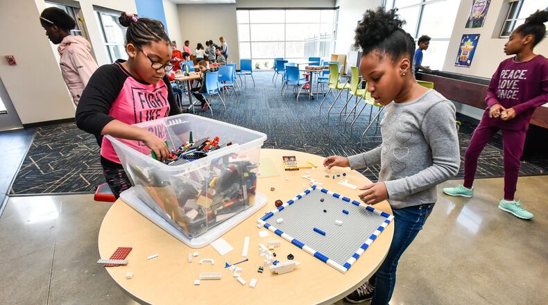 Fourth-graders Ayana, left, and Zoei, right, build with Legos on opening day at the Boys and Girls Club of West Chester/Liberty in the new location on Cincinnati Dayton Road in West Chester Township Thursday, Jan. 4. NICK GRAHAM/STAFF