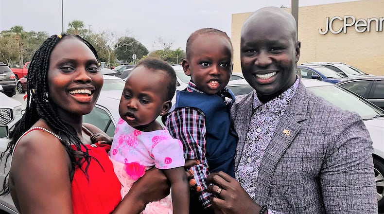 Master Sgt. Deng Pour, manager of readiness and resource support for the Chaplain Corps at Headquarters, Air Force Materiel Command, stands with his wife and two children in Dayton. U.S. AIR FORCE PHOTO/Michele Ruff