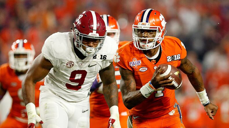 GLENDALE, AZ - JANUARY 11:  Deshaun Watson #4 of the Clemson Tigers runs the ball in the third quarter against Da'Shawn Hand #9 of the Alabama Crimson Tide during the 2016 College Football Playoff National Championship Game at University of Phoenix Stadium on January 11, 2016 in Glendale, Arizona.  (Photo by Christian Petersen/Getty Images)