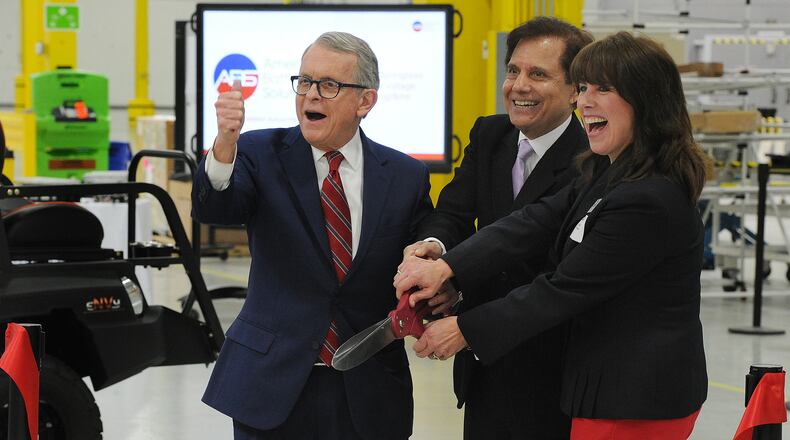 At the re-dedication event for American Battery Solutions in Springboro, From left, Ohio Governor, Mike DeWine, Founder, Chairman & CEO, Subhash Dhar and Springboro City Council member Becky Iverson are all smiles during the ribbon cutting Monday April 4, 2022. MARSHALL GORBY\STAFF
