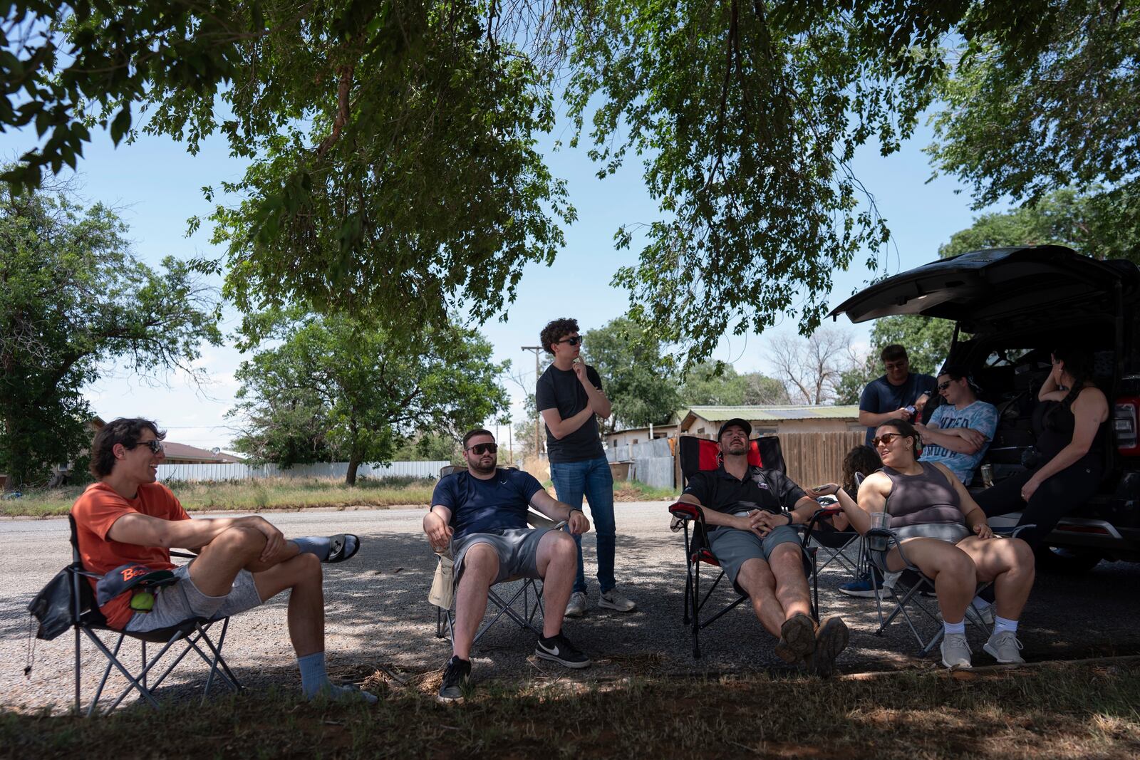 Project ICECHIP members, from left, Ethan Mok, Logan Bundy, Nathan Sonntag, Victor Gensini and Katie Wargowsky sit in chairs next to the command vehicle waiting for storms to develop Friday, June 6, 2025, in Morton, Texas. (AP Photo/Carolyn Kaster)