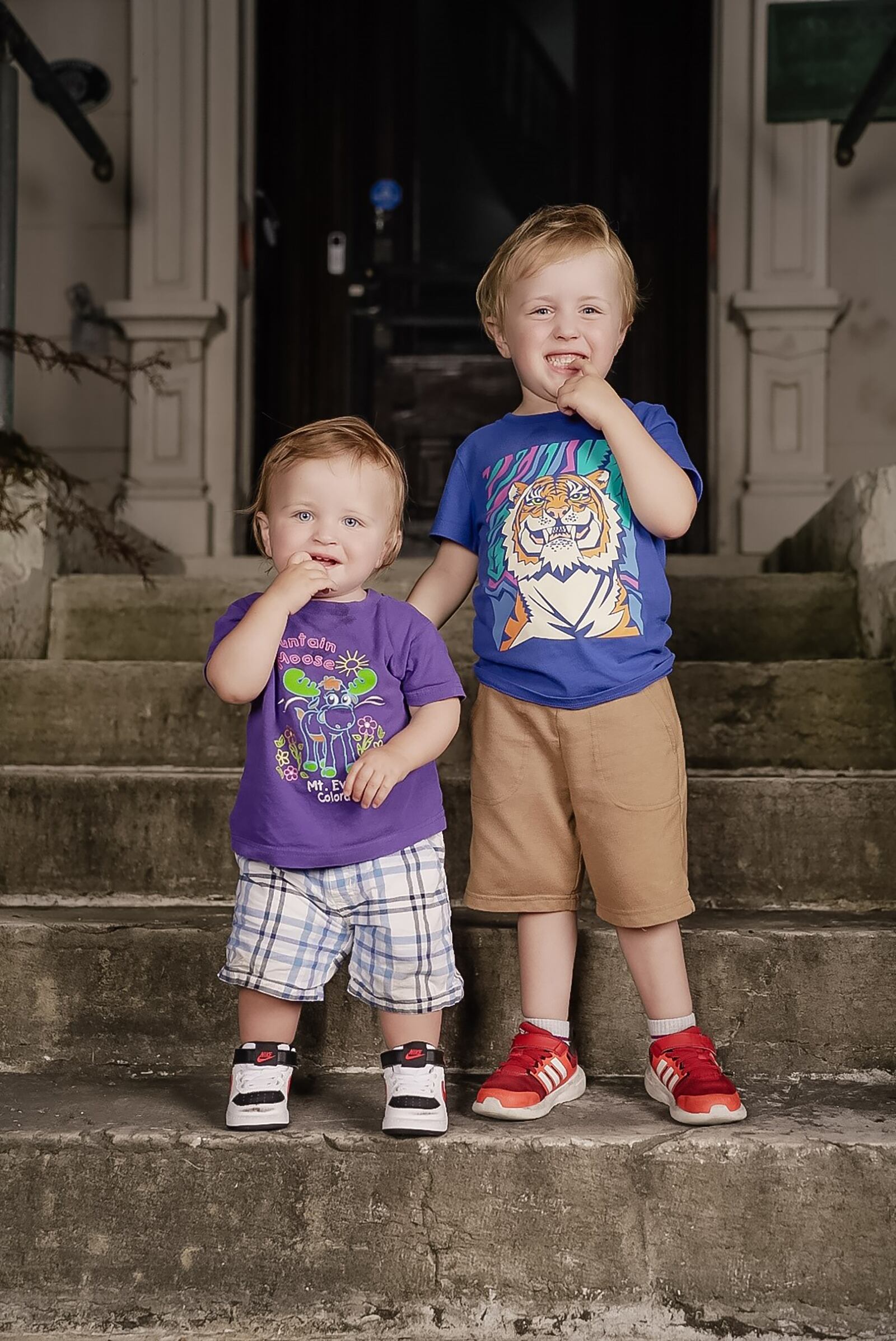 Finn (L) and River share a brotherly moment in front of their new home in Dayton in 2023. The family lives in the newly renovated Isaac Pollick House in Dayton, build in 1876.