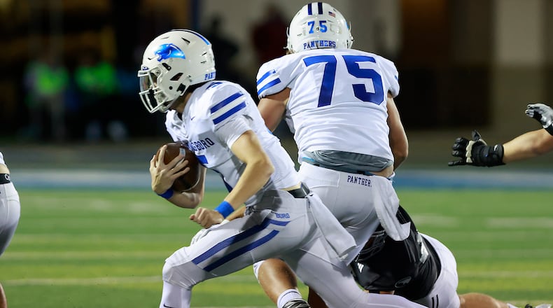 Springboro's Max Miller carries the ball against Fairmont. BILL LACKEY/STAFF