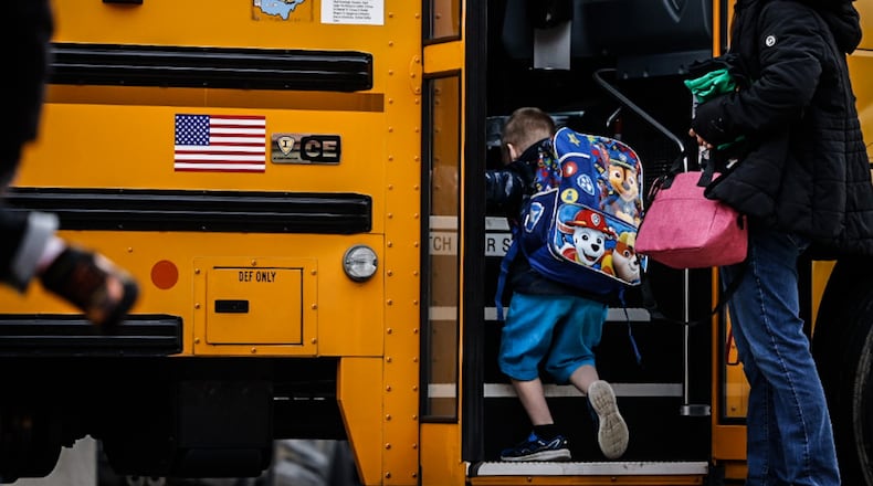 Students at Wright Brothers Elementary head to the bus for a ride home Tuesday December 13, 2022. Schools across the region are still struggling to cover bus routes including Huber Heights schools. JIM NOELKER/STAFF