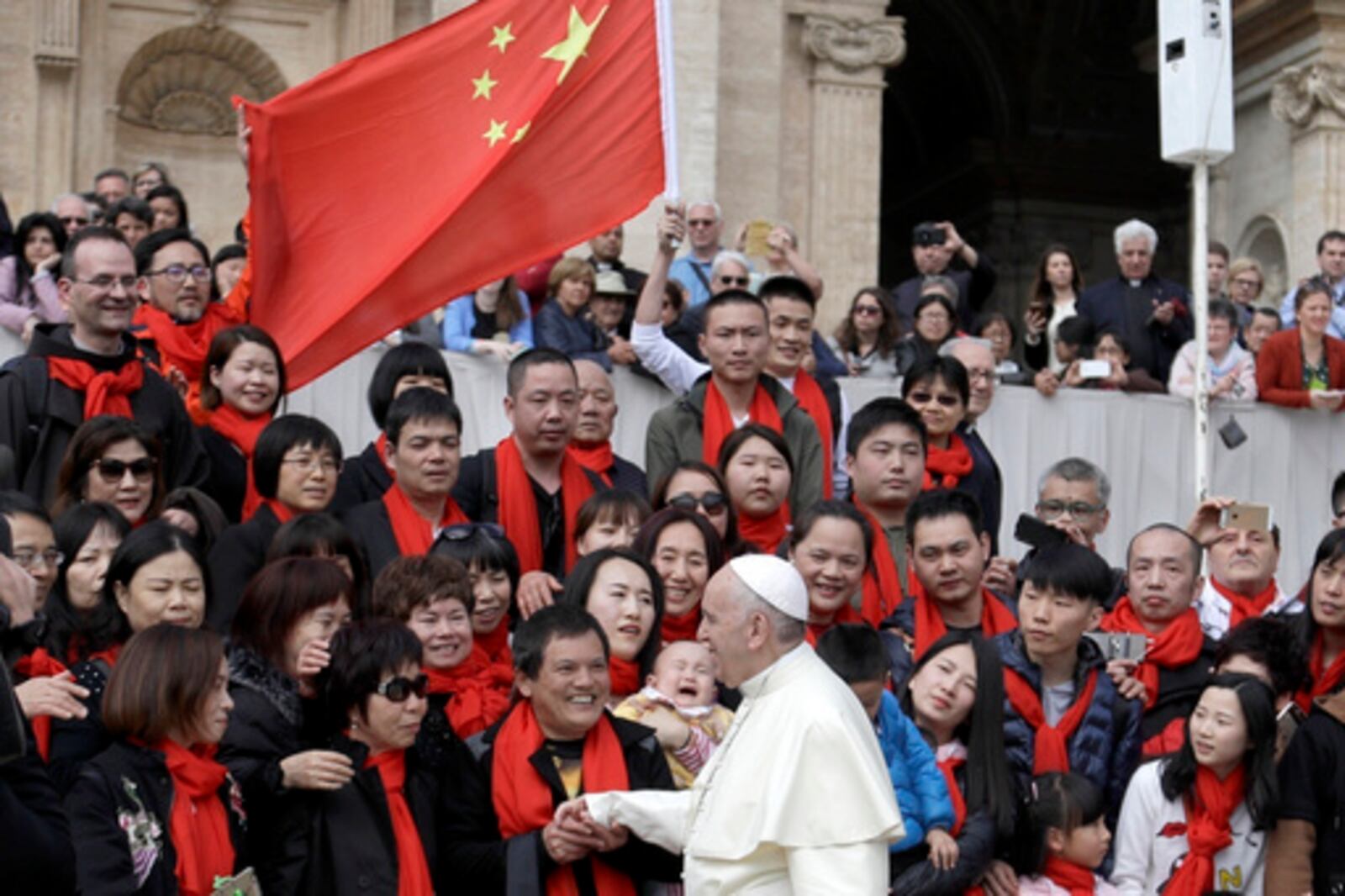 FILE - In this April 18, 2018 file photo, Pope Francis meets a group of faithful from China at the end of his weekly general audience in St. Peter's Square, at the Vatican. The Vatican on Tuesday, Sept. 29, 2020, answered its critics and justified its decision to pursue an extension of an agreement with China over bishop nominations, acknowledging difficulties but insisting that limited, positive results had been achieved.(AP Photo/Gregorio Borgia, file)