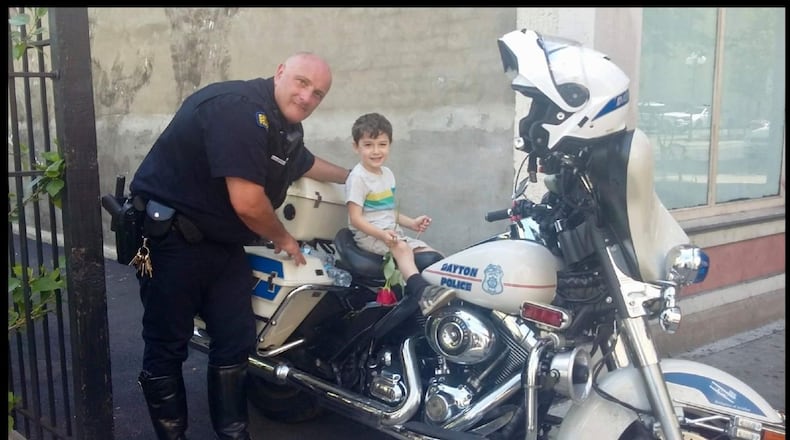 In the days after the Oregon District shootings, Officer Jimmy Howard of the Dayton Police Department’s motor unit poses with Kilo Gibson, who lives in the Oregon District just a block from the shooting. CONTRIBUTED