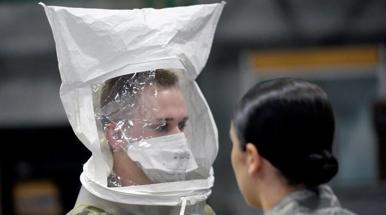 Airman 1st Class Nicholas Grogg (left) followed directions from Airman 1st Class Abigail Pack, 88th Aerospace Medicine Squadron, during testing of the mask fit. (U.S. Air Force photo/Ty Greenlees)