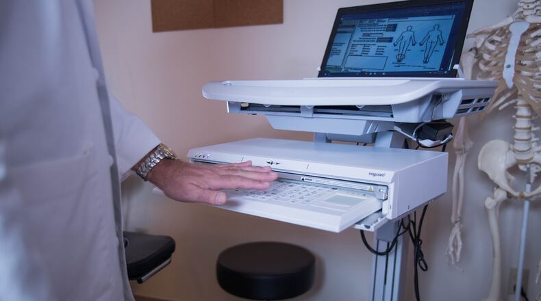 Seen in a health-care setting, the Vioguard keyboard can slide, with the push of a button, into its case, where ultraviolet rays kill germs. (Vioguard)