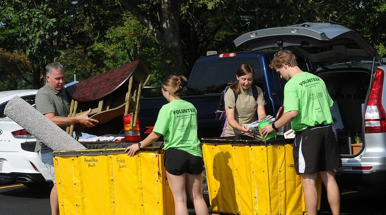 Move in day Wednesday, Aug. 23, 2023 at Wright State University, from left, Dave Blocher, Volunteer McLala Stafford, Sarah Blocher and Volunteer Matthew Correll. MARSHALL GORBY\STAFF