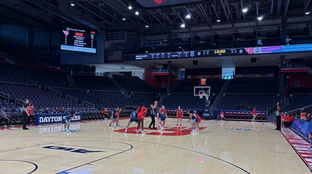 In a game played without a crowd because of the severe weather outside, referee Kelsey Reynolds throws up the ball for the opening tip between Rhode Island's 6-foot-5 Abina Syla and Dayton's 6-2 center Molly O'Riordan on Sunday, Jan. 26, 2026 at UD Arena. TOM ARCHDEACON / CONTRIBUTED PHOTO