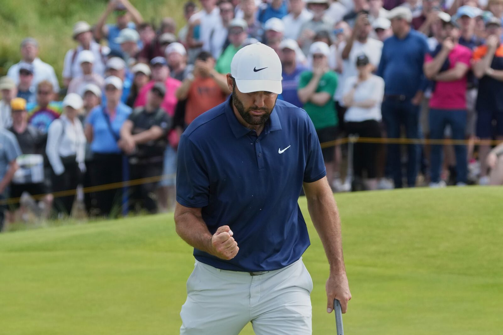 Scottie Scheffler of the United States reacts after putting on the 6th green during the final round of the British Open golf championship at the Royal Portrush Golf Club, Northern Ireland, Sunday, July 20, 2025. (AP Photo/Jon Super)