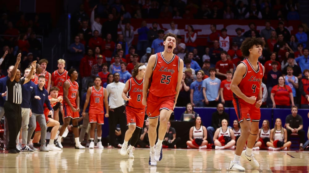 Liberty celebrates after a basket against Dayton on Saturday, Dec. 20, 2025, at UD Arena. David Jablonski/Staff