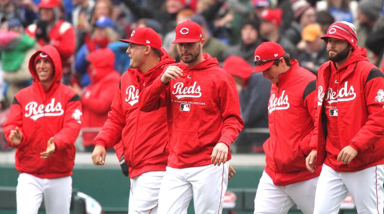 The Reds celebrate a victory against the Cubs on Monday, April 2, 2018, at Great American Ball Park in Cincinnati. David Jablonski/Staff