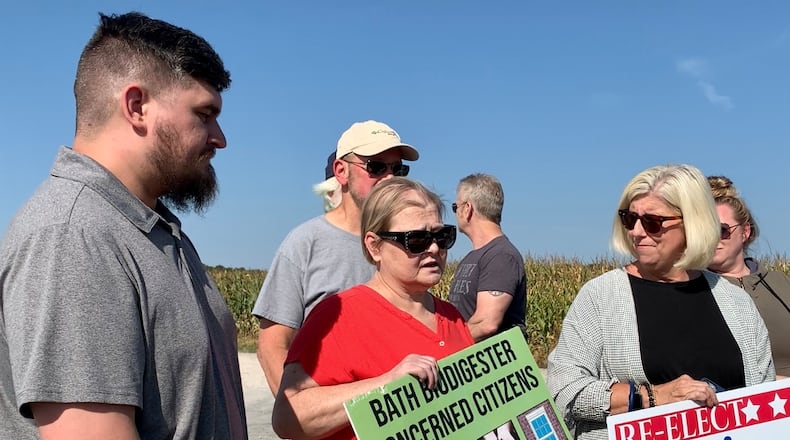 Jude Eschete, Lorie Venable, and Pam Gayheart stand across the street from the Dovetail biodigester in Bath Twp. Wednesday after the digester’s parent company Renergy agreed to close the facility Wednesday. LONDON BISHOP/STAFF