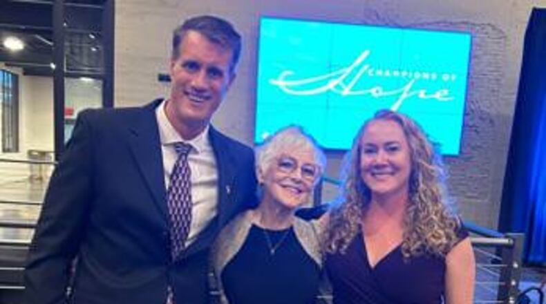 Jan Hillman (center) with Dino Dimitrouleas and Elesha Snyder, co-founder and vice chair of Breast Wishes Foundation