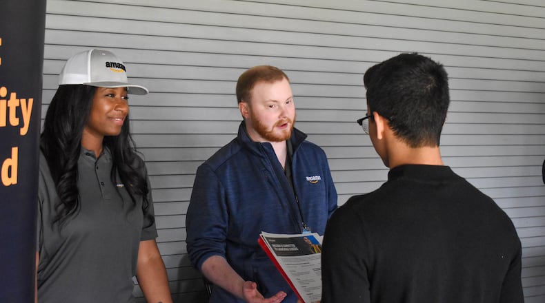 Representatives from Amazon speak with a young attendee at the 2022 Youth Job Fair.