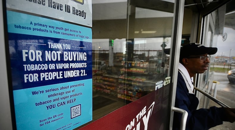 A signed on the door, thanking people not to buy tobacco or vaping products for people under the age of 21 at the BP station on Edwin C Moses Boulevard. MARSHALL GORBY \STAFF