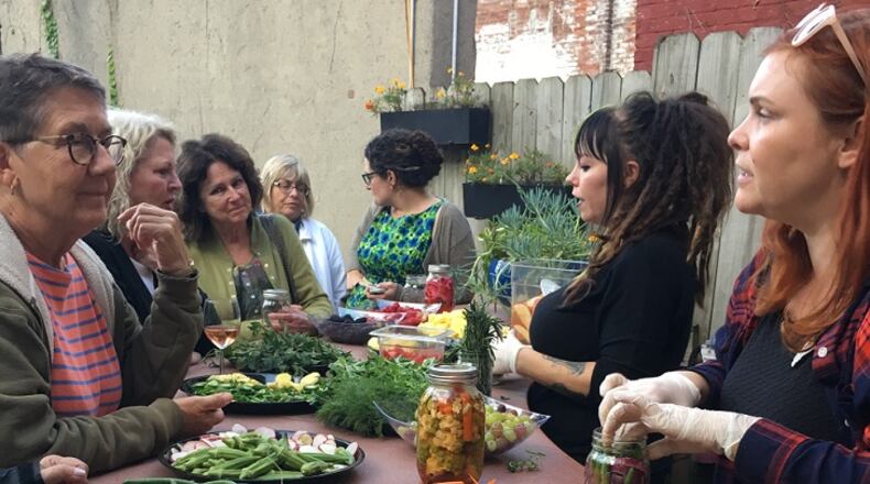 Lily’s Bistro owner Emily Mendenhall (far right) and bar manager Amber Brady at Lily’s Bistro’s Garden Party in September 2017. File photo by Alexis Larsen