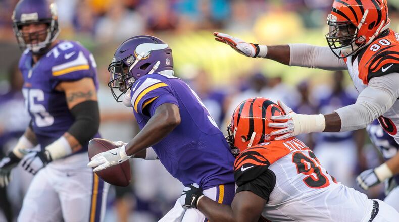 Minnesota Vikings quarterback Teddy Bridgewater gets sacked by Geno Atkins and Michael Johnson, right, with the Cincinnati Bengals during the first quarter of their first pre-season game Friday, Aug. 12 at Paul Brown Stadium in Cincinnati. NICK GRAHAM/STAFF