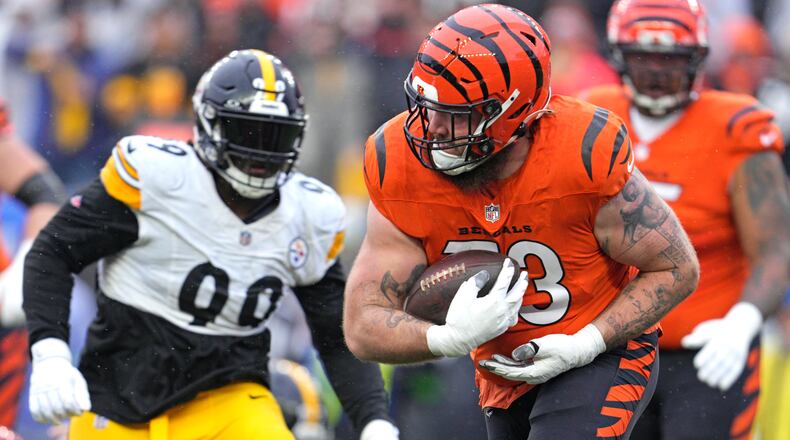 Cincinnati Bengals offensive tackle Jonah Williams, center, runs after recovering a fumble by Pittsburgh Steelers quarterback Kenny Pickett during the first half of an NFL football game in Cincinnati, Sunday, Nov. 26, 2023. (AP Photo/Jeffrey Dean)