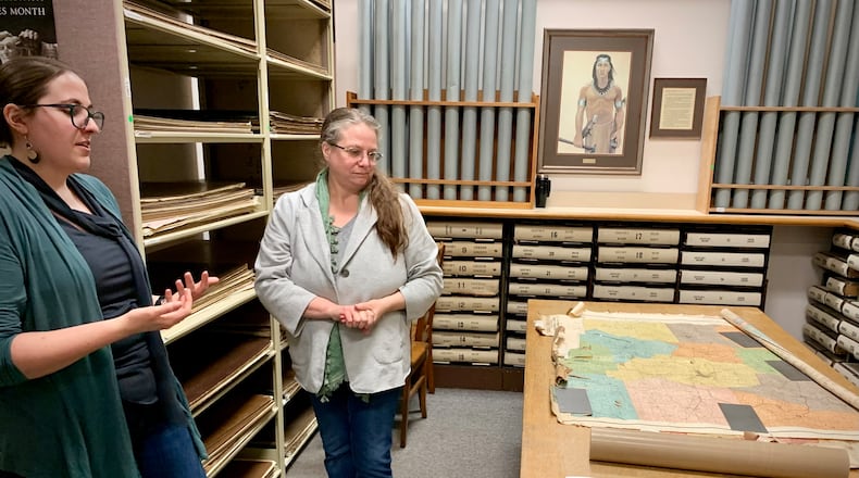 Greene County Archivists Mary McKinley (left) and Robin Heise (center) explain the various exhibits the department has developed for the 50th anniversary of the 1974 tornado. LONDON BISHOP/STAFF