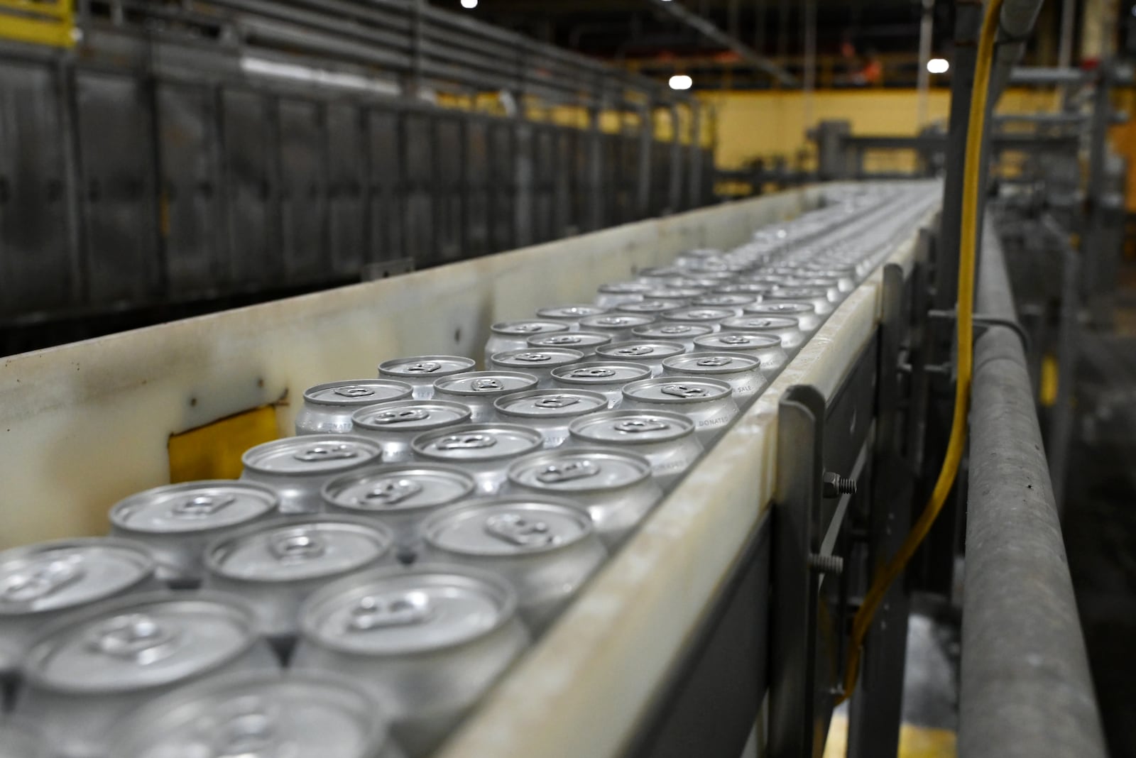 Once a year, Molson Coors in Trenton produces canned water to distribute to disaster areas around the country. This year, the Trenton brewery has doubled its output to between 600,00 to 800,000 cans of water. It cans the water in a single day in April, but this year they delayed the run due to storms and tornado activity in the area. Pictured is part of the canning process done on May 12, 2025. MICHAEL D. PITMAN/STAFF