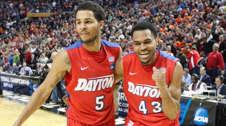 Dayton's Vee Sanford, right, pumps his fist and leaves the court with Devin Oliver after hitting the game-winning shot against Ohio State in the second round of the NCAA tournament on Thursday, March 20, 2014, at the First Niagara Center in Buffalo, N.Y. David Jablonski/Staff