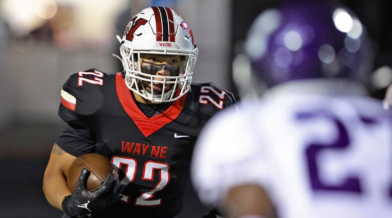 Wayne's Isaiah Thompson carries the ball around the end against Middletown during Friday's playoff game. BILL LACKEY