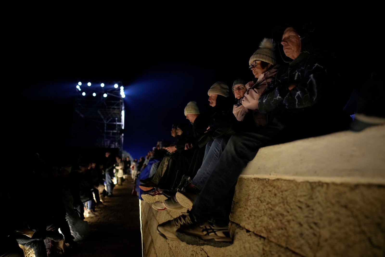 Attendees wait for the start of the "Spirit of Place" ceremony and dawn memorial service at the Anzac Cove beach, the site of the April 25, 1915, World War I landing of the ANZAC (Australian and New Zealand Army Corps) on the Gallipoli peninsula, near Canakkale, Turkey, early Friday, April 25, 2025. (AP Photo/Emrah Gurel)