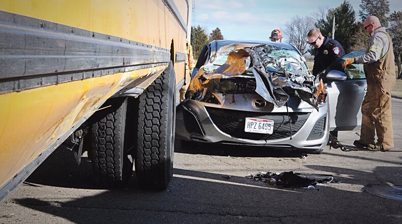 A car and a Miamisburg school bus were both damaged in a wreck at the intersection of South Heincke and Maue roads Thursday afternoon. MARSHALL GORBY.