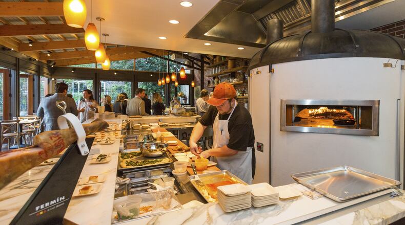 An undated handout photo of a chef preparing a dish at OvenBird, a restaurant that only uses a wood-burning hearth in Birmingham, Ala. Inspired by the live-fire cooking traditions of Spain, Uruguay, Portugal, and Argentina, the restaurant’s cast-iron hearth also plays homage to Birmingham’s long history as a center of iron and steel production. (Handout via The New York Times)