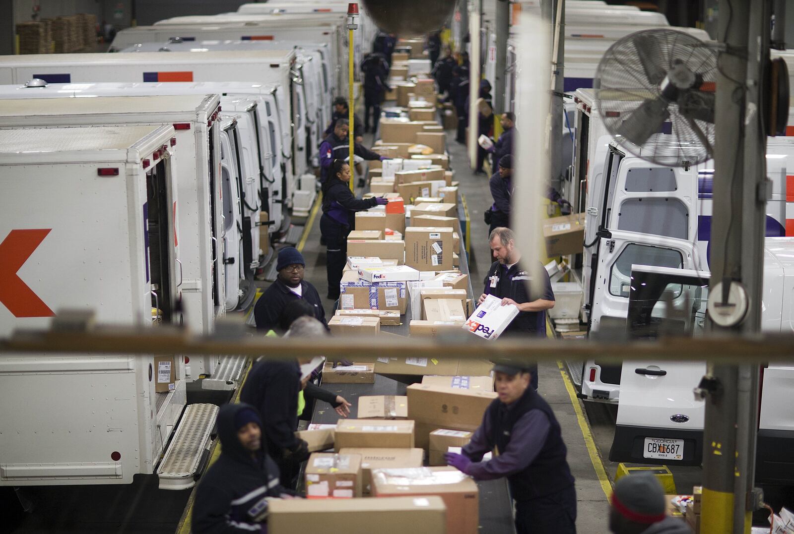 FILE - In this Dec. 15, 2014 file photo, packages are sorted on a conveyer belt before being loaded onto trucks for delivery at a FedEx facility in Marietta, Ga. FedEx, UPS and e-commerce retailers are trying to avoid the problems that occurred last year when severe winter weather and a surge in late orders caused delivery delays. (AP Photo/David Goldman, File)