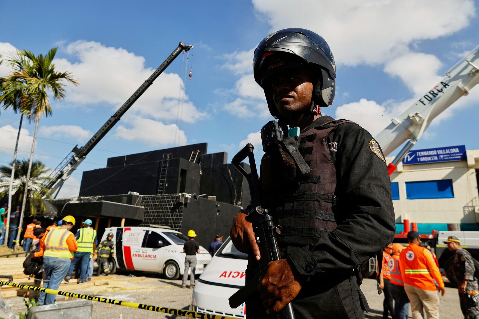 Police cordon off the area as rescue workers search for survivors at the Jet Set nightclub after its roof collapsed during a merengue concert in Santo Domingo, Dominican Republic, Tuesday, April 8, 2025. (AP Photo/Eddy Vittini)