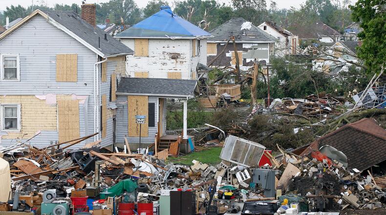 Tornado damage debris fills this Harrison Twp. neighborhood off Wagner Ford Rd. where ODOT workers were hauled away many dump truck loads on Wednesday. TY GREENLEES / STAFF