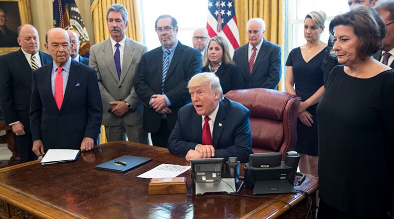 President Donald Trump signs a directive regarding steel imports and national security, related to the Trade Expansion Act of 1962, in the Oval Office of the White House, in Washington, April 20, 2017. In remarks here Thursday, Trump added a new name to the list of countries that he accuses of preying on American workers and exploiting American trade policies: Canada.